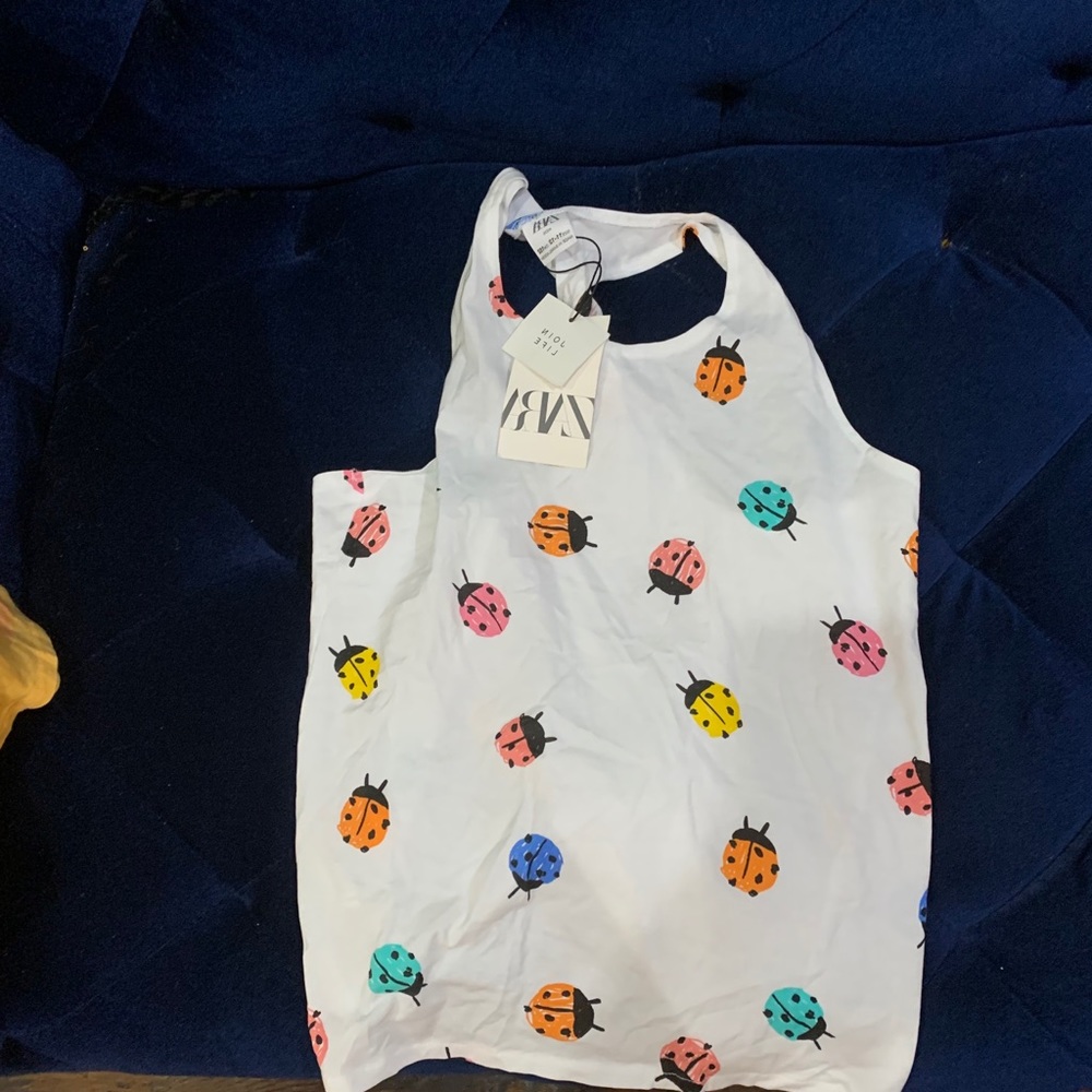 White sleeveless shirt with ladybug design